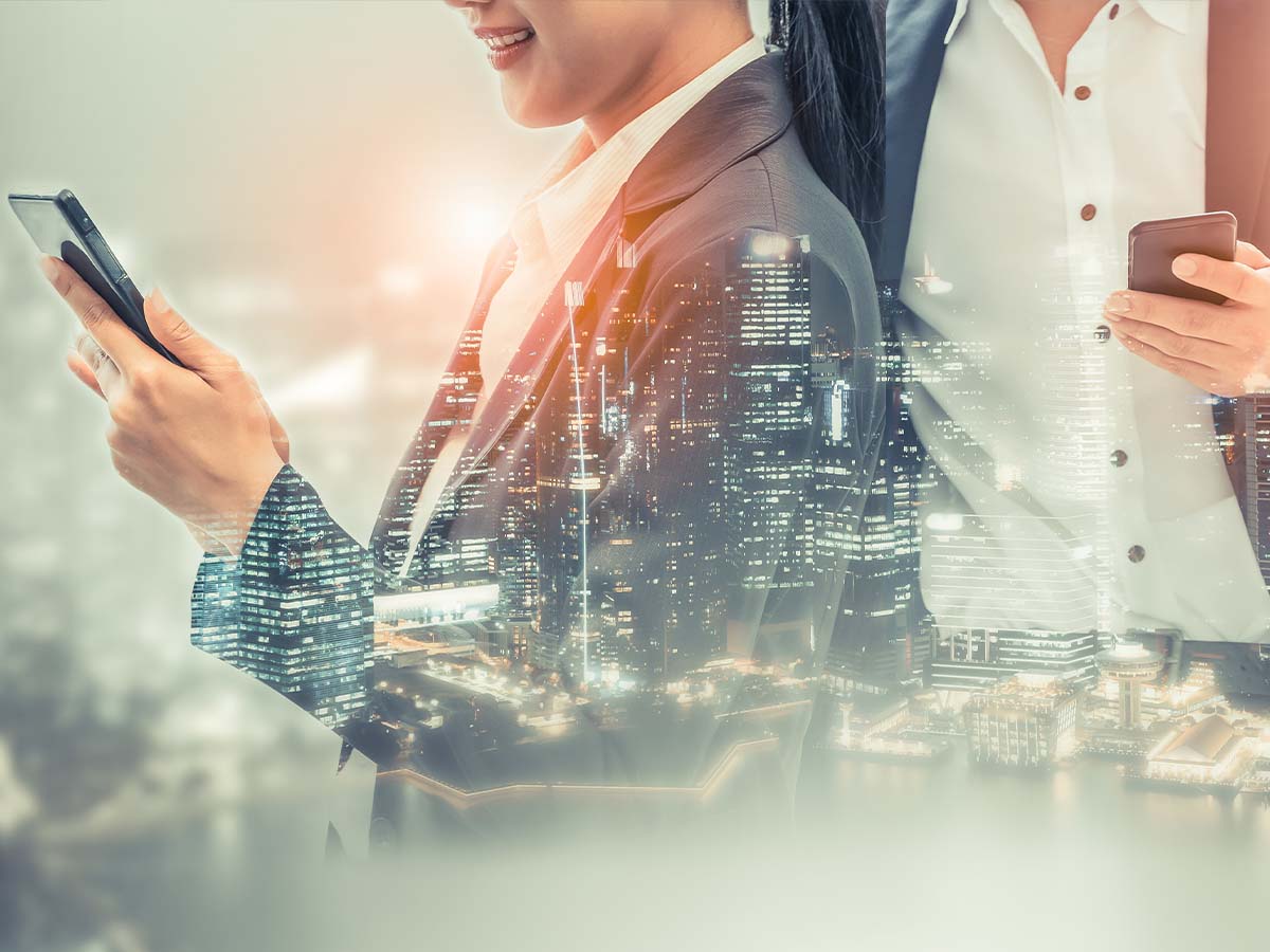 A rendered image of two people holding smartphones overlaid by a cityscape
