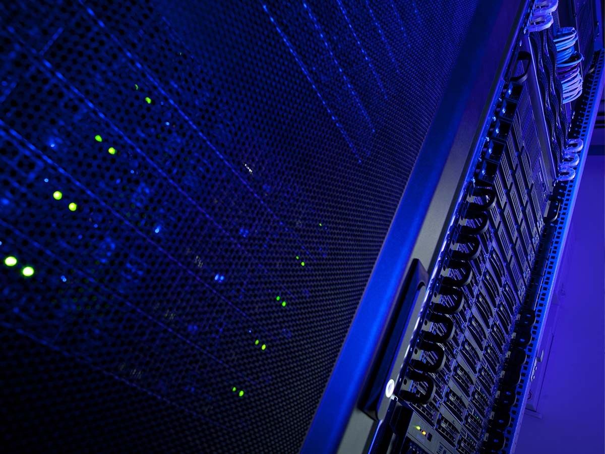 A server in a dark room lit by blue lights