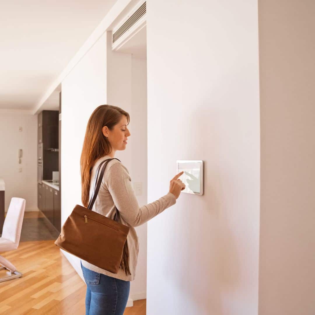 Woman setting a home security system