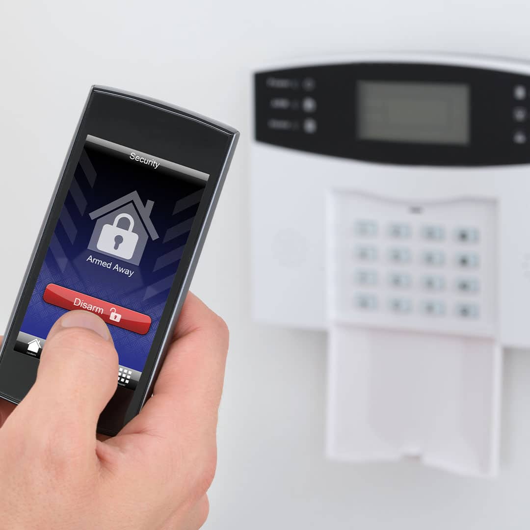 Woman setting a home security system