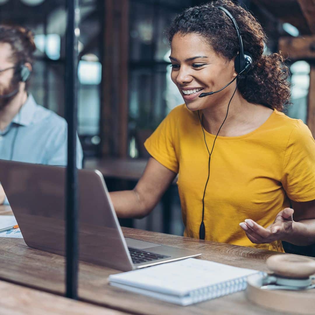 person talking on headset on laptop