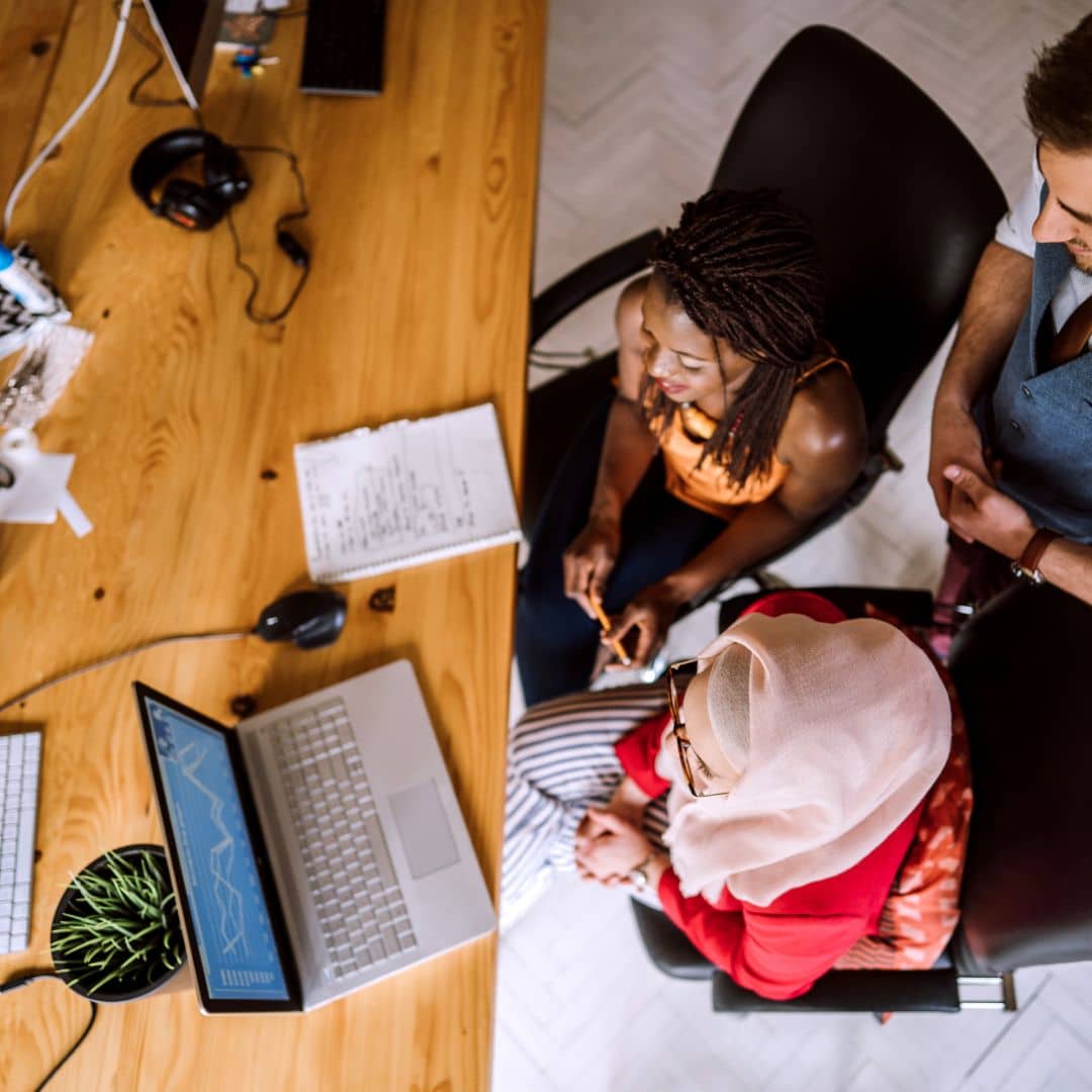 overhead view of people working on laptop