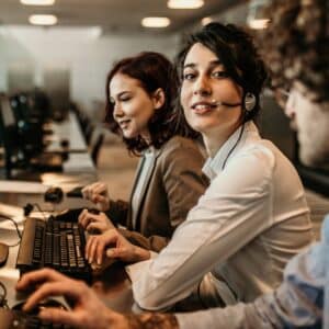 person wearing headset in front of desktop computer