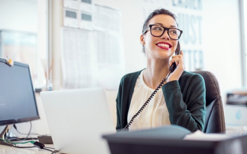 A woman on the phone at a desk