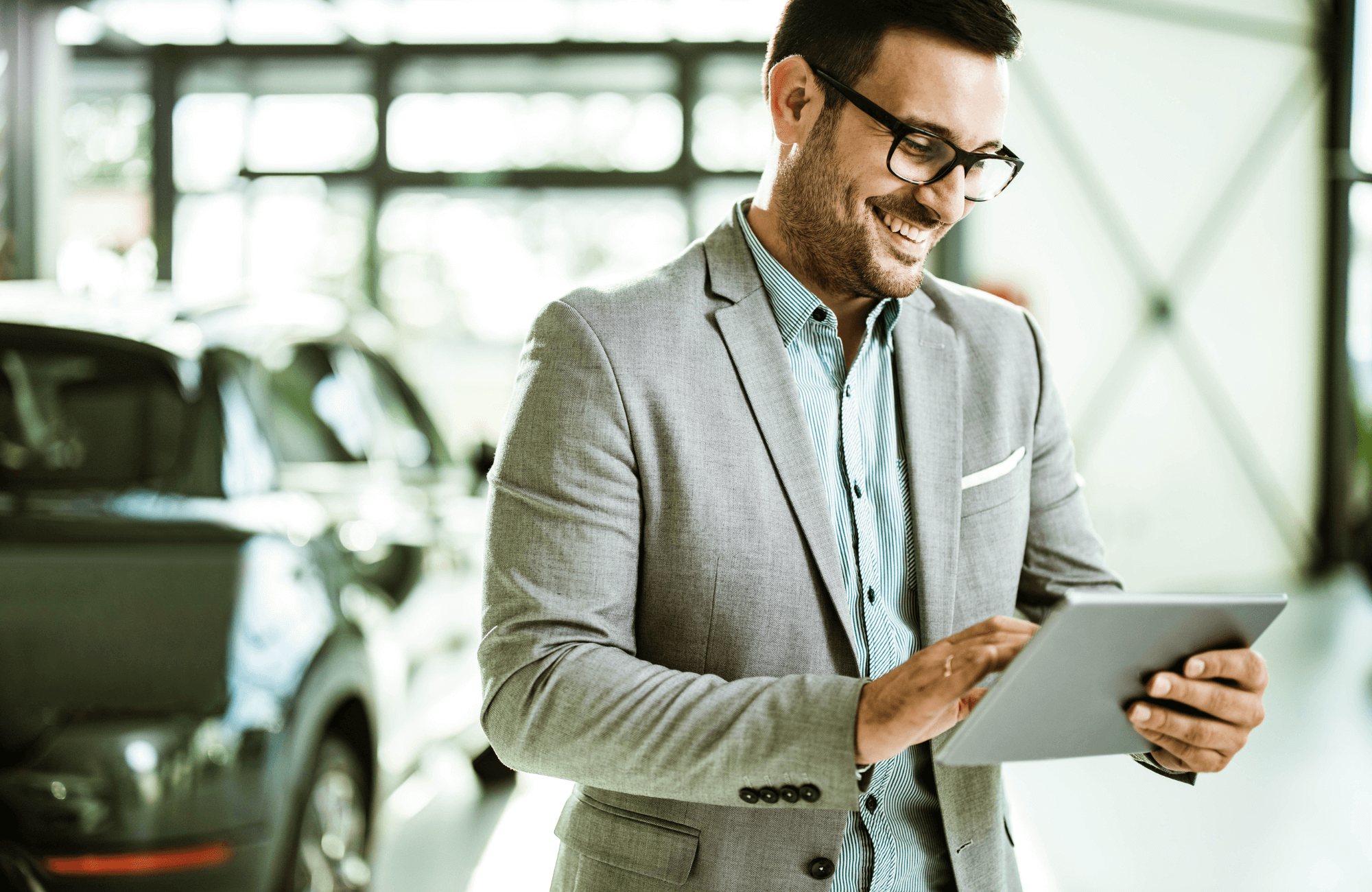 deal-feature A car dealership salesman on his tablet