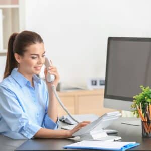Dental receptionist answering the phone