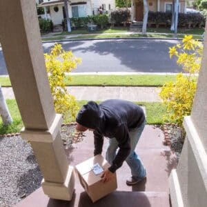 man trying to take package from front porch