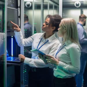 IT workers pointing at server racks