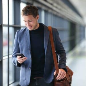 business man in the airport checking messages